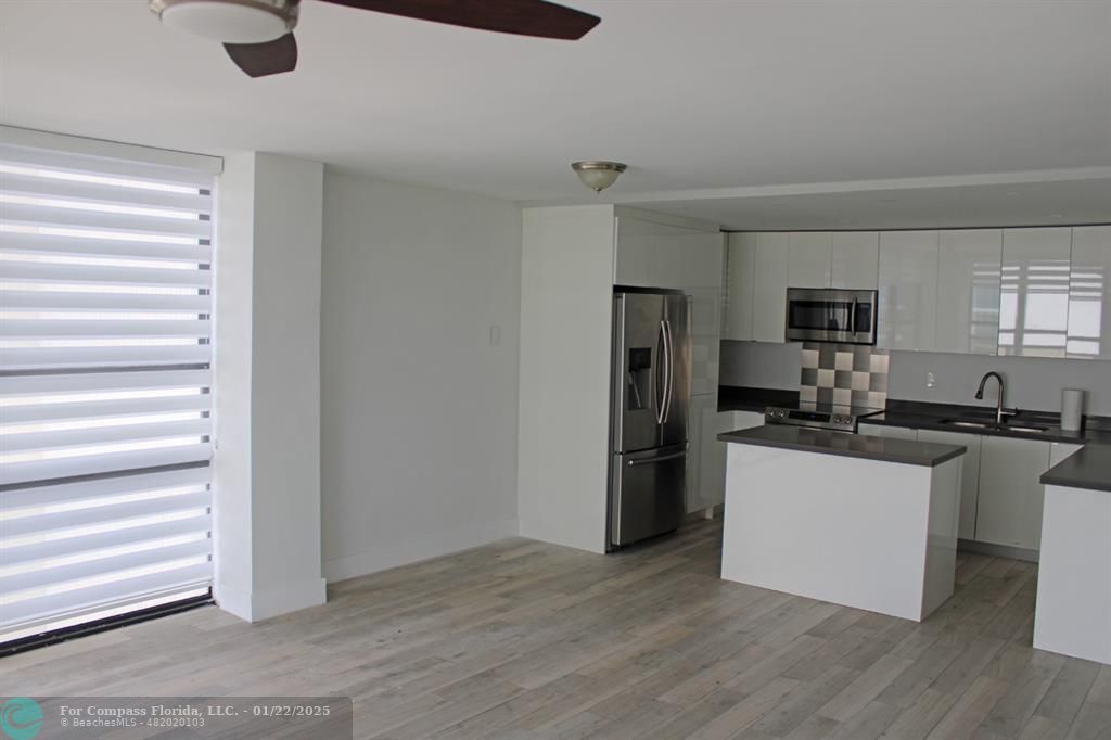 a kitchen with a refrigerator and a stove top oven