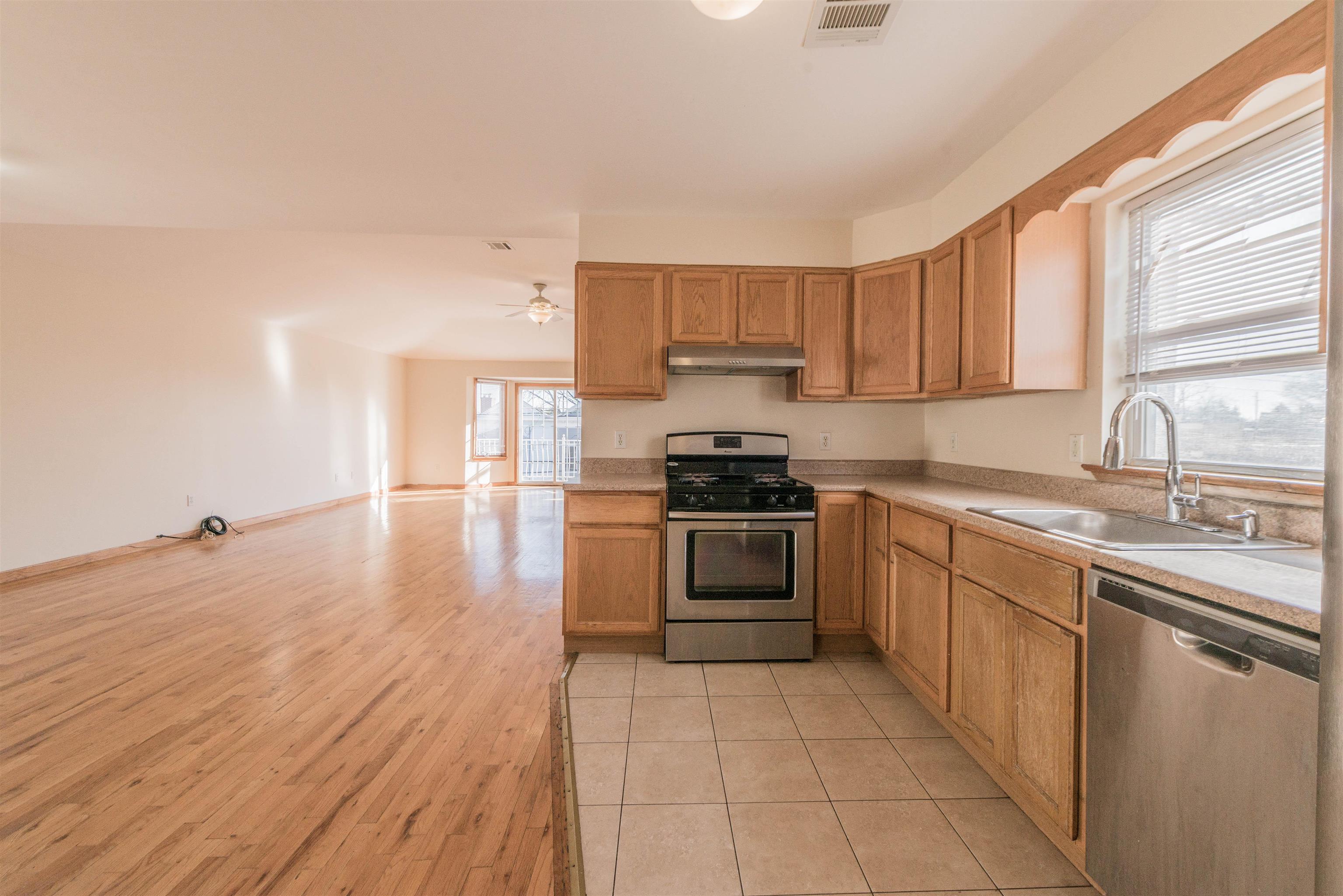 a kitchen with a sink a stove and cabinets