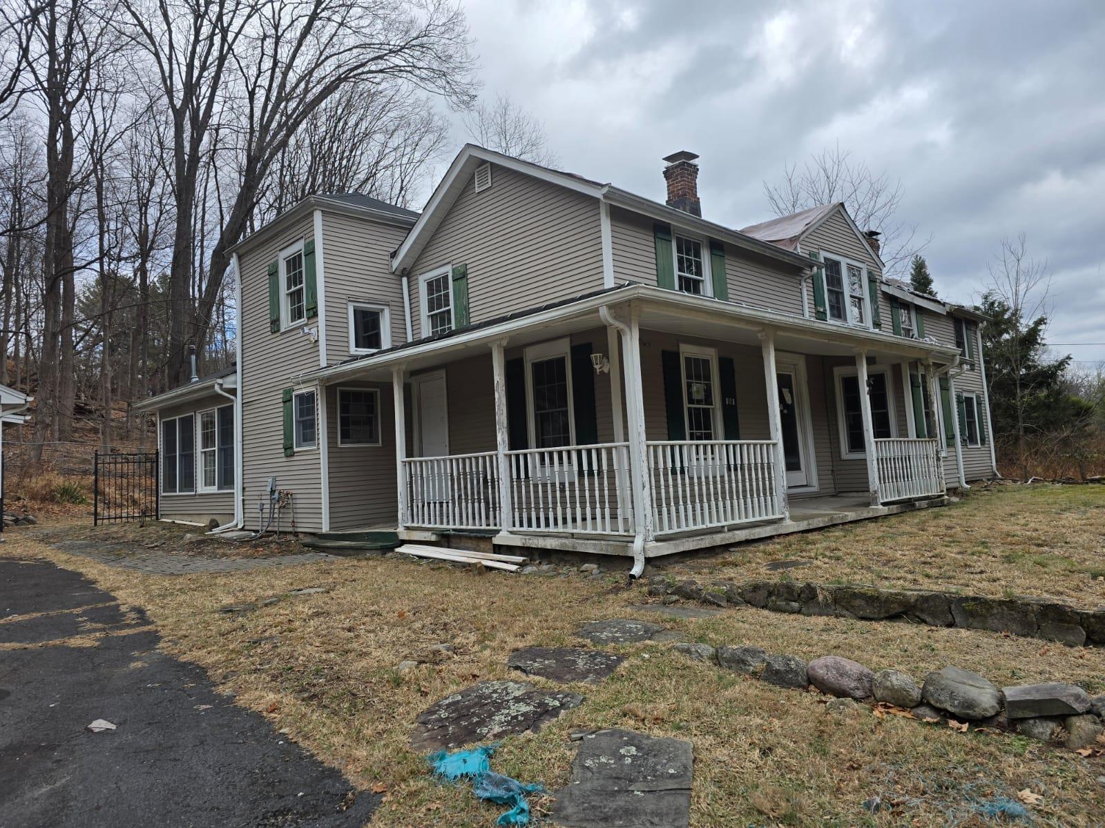 Farmhouse-style home with covered porch