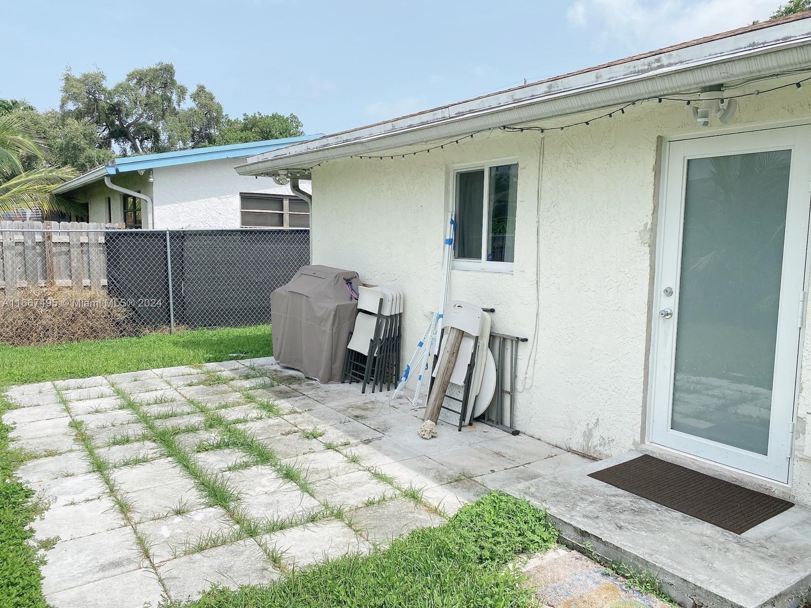 a view of a backyard with a patio