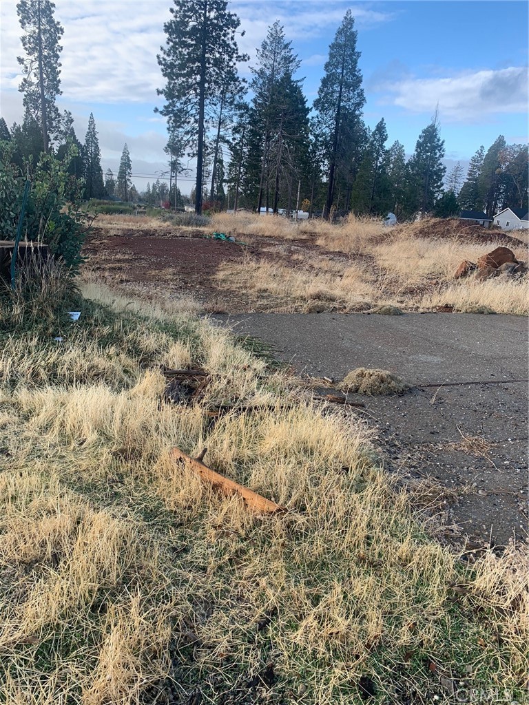 a view of dirt yard with mountain view