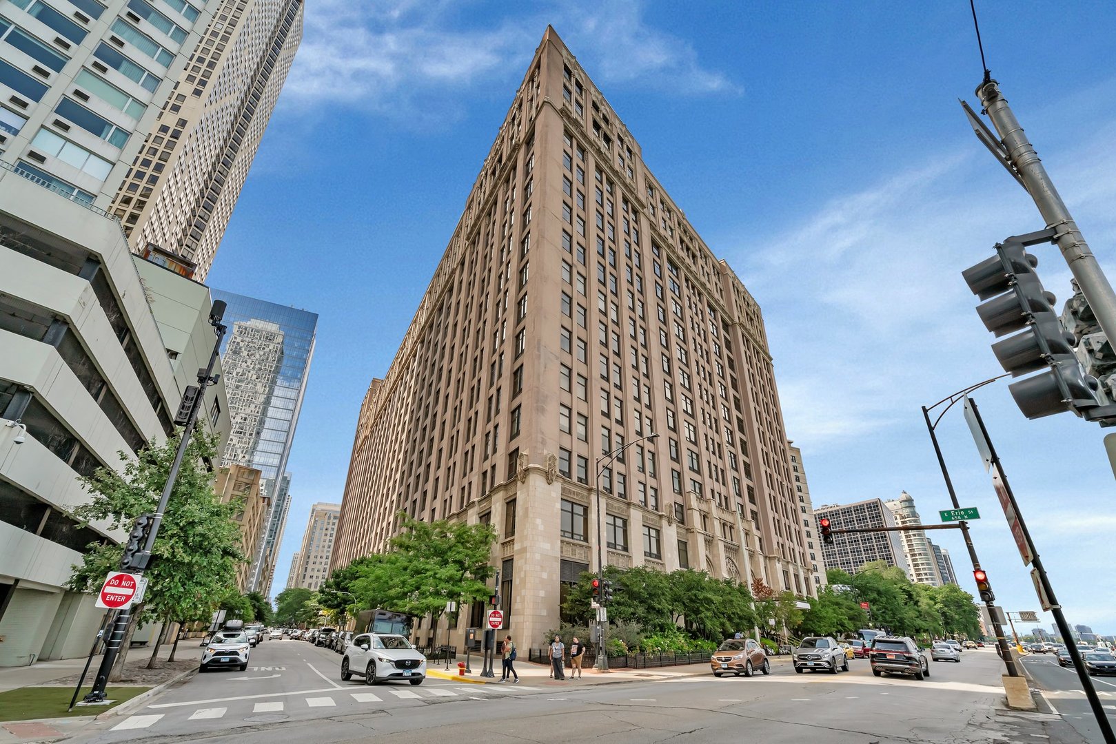 a view of a tall building next to a road