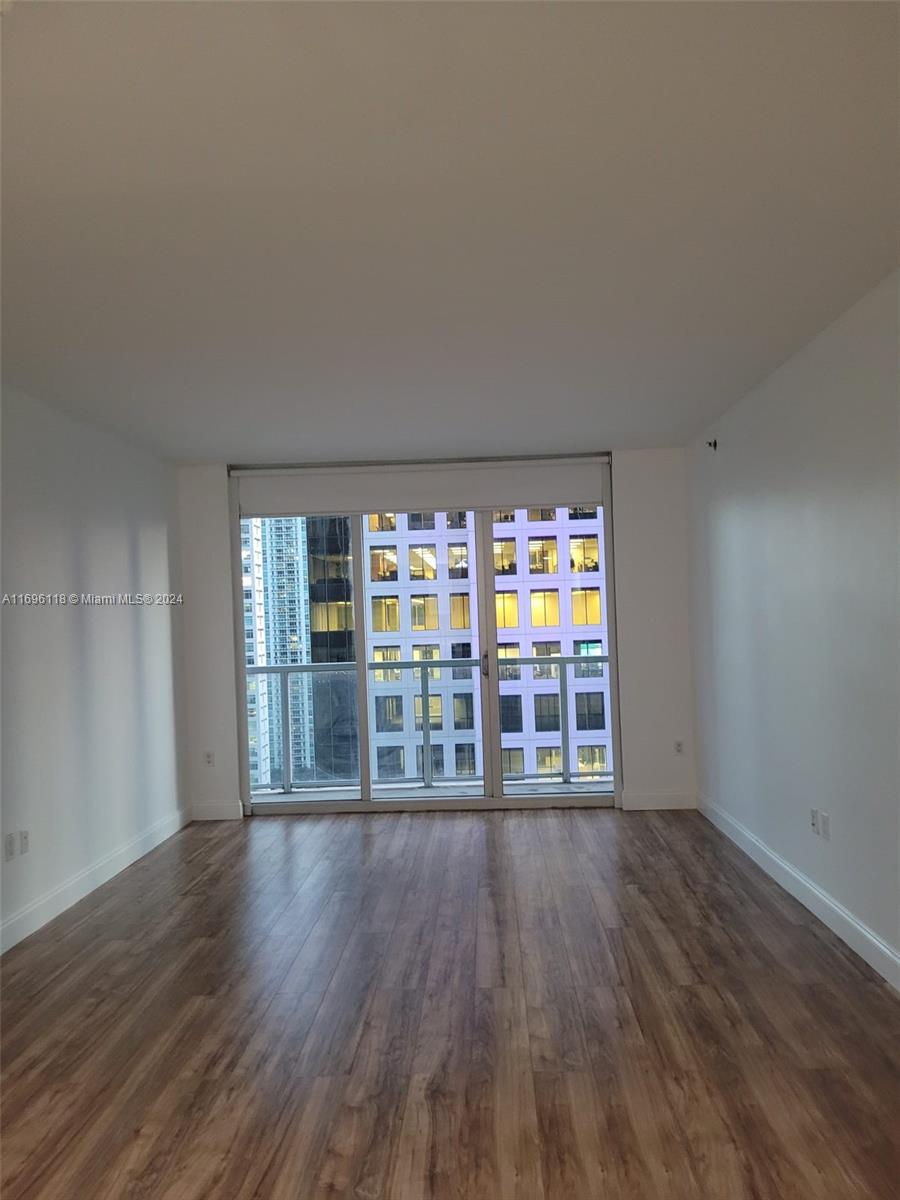 a room with wooden floors and large window