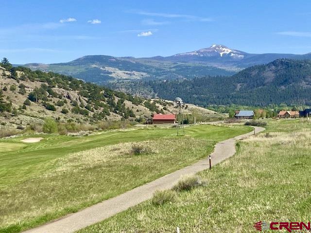 a view of an houses with a yard and mountain