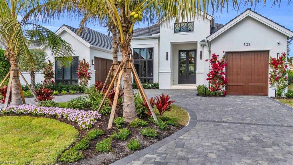 a view of a house with fountain and a palm tree