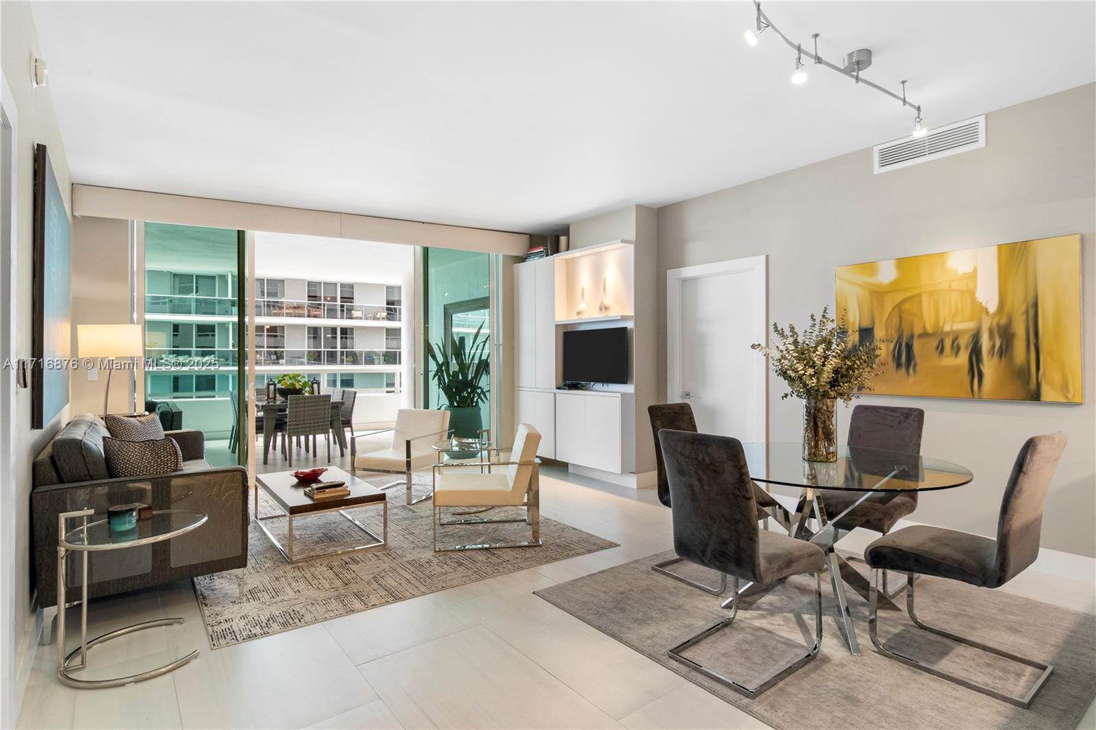 a living room with furniture and large windows