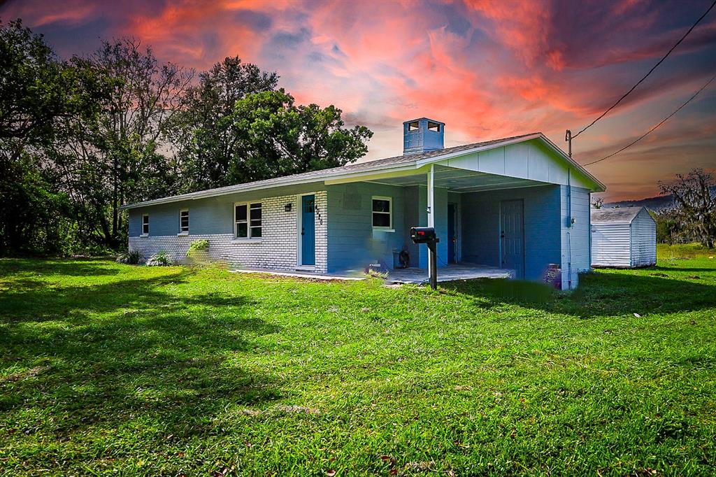 a front view of house with yard and outdoor seating