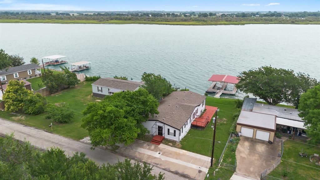 an aerial view of ocean with residential house with outdoor space and seating