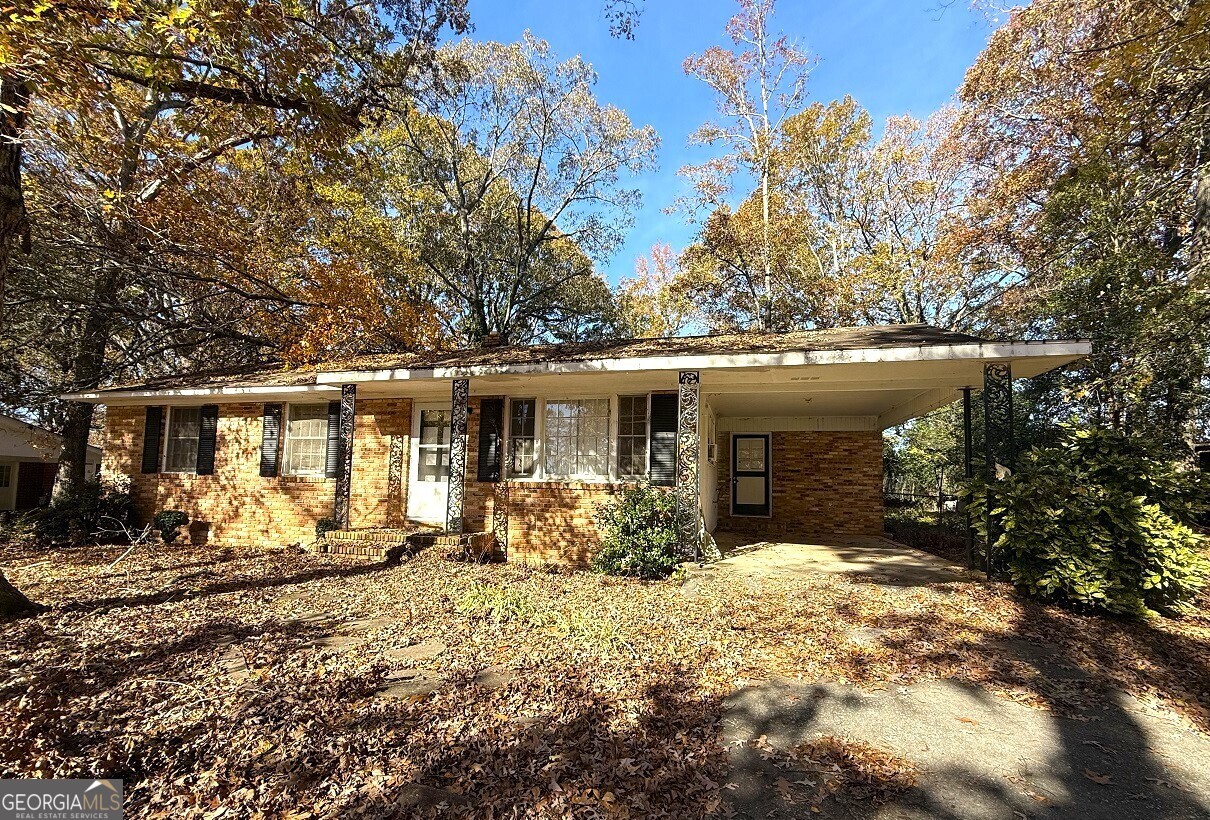 a front view of house with yard outdoor seating and barbeque oven