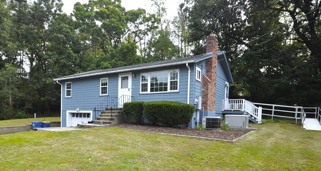 a view of a house with a yard porch and sitting area