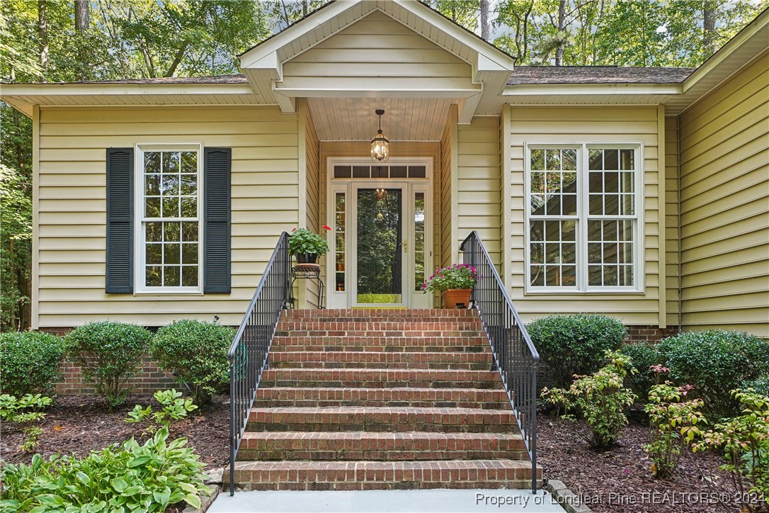 a front view of a house with potted plants