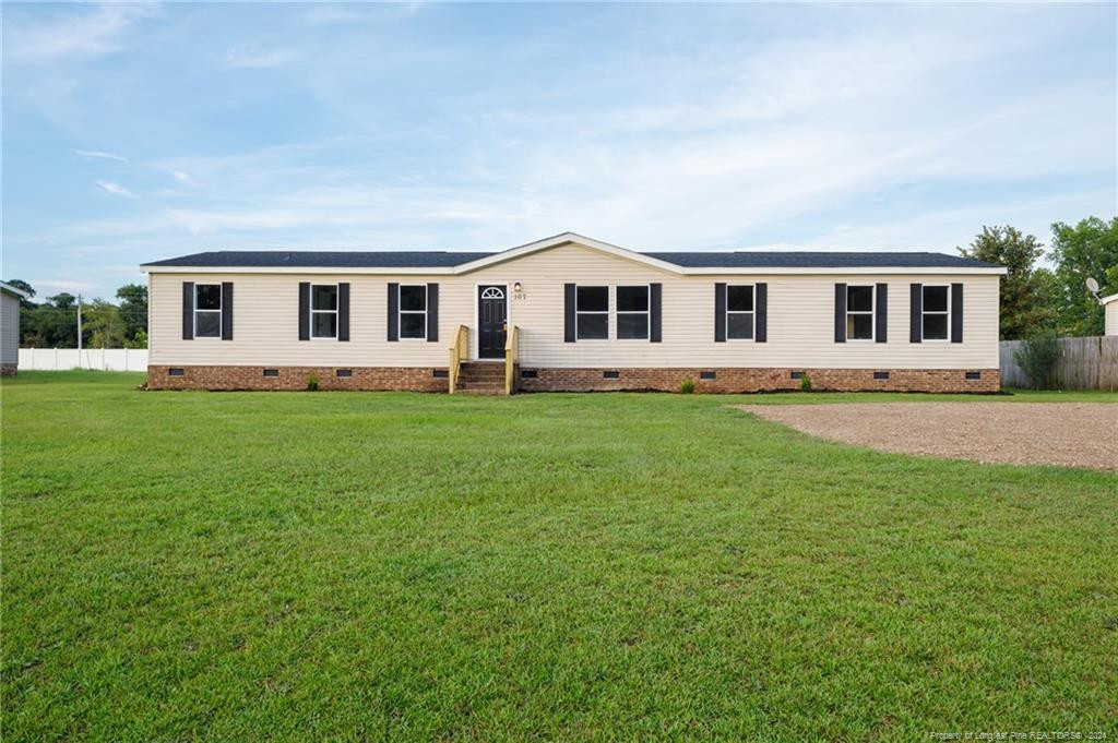 a front view of house with yard and green space