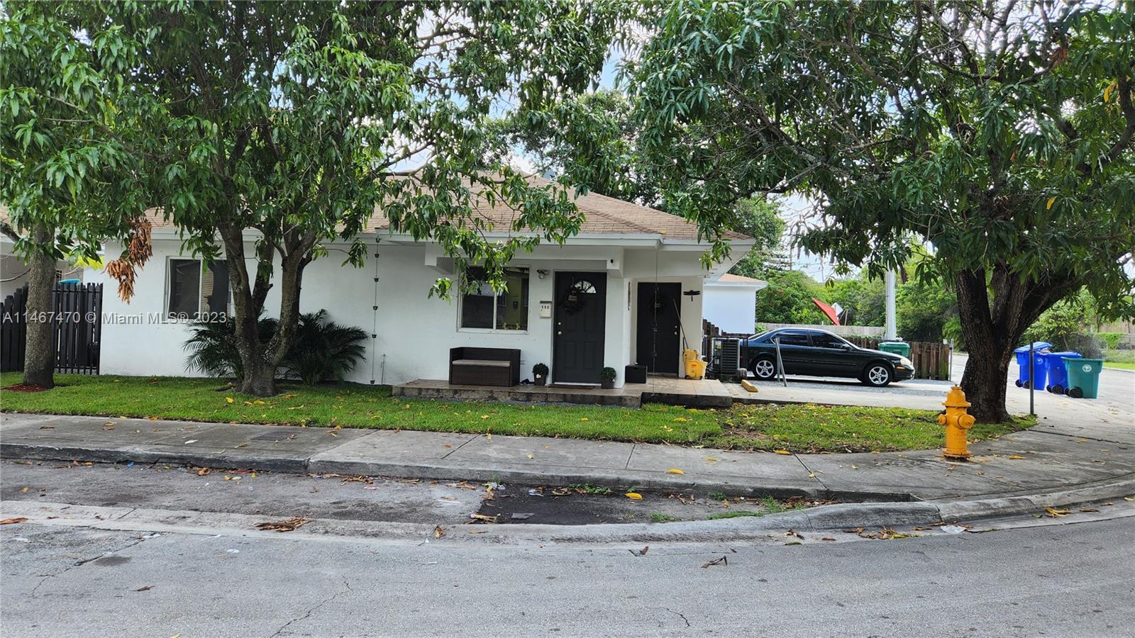 a front view of a house with a yard and a garage