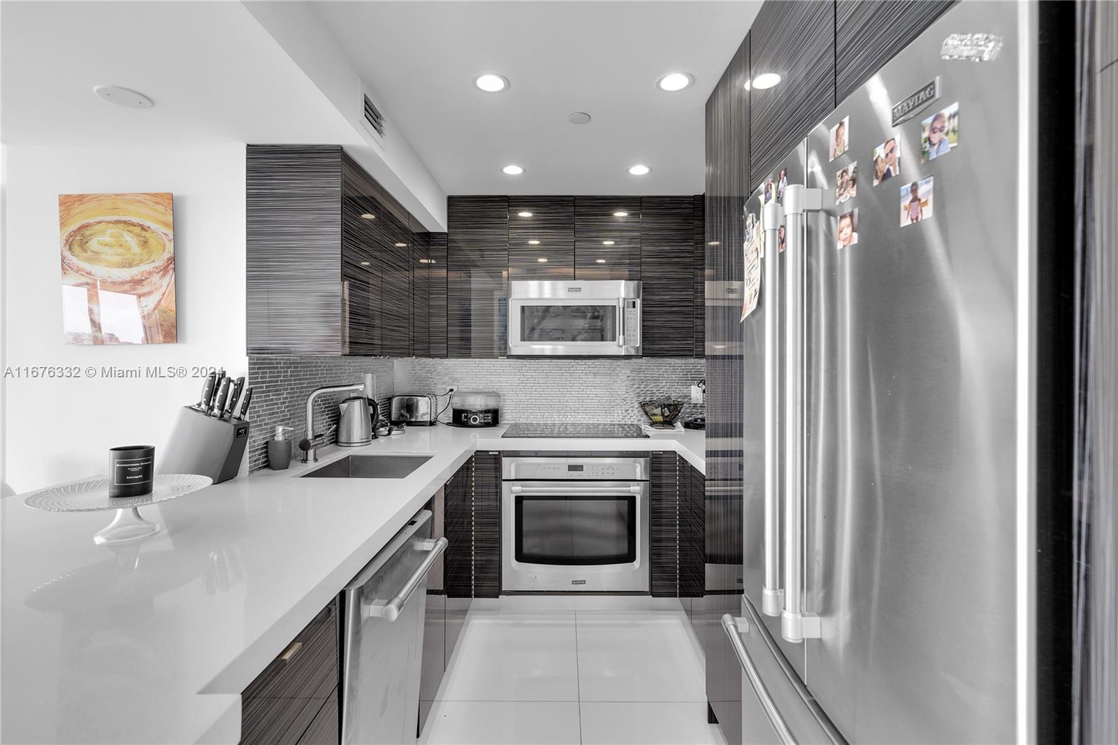 a kitchen with stainless steel appliances granite countertop a sink and a stove