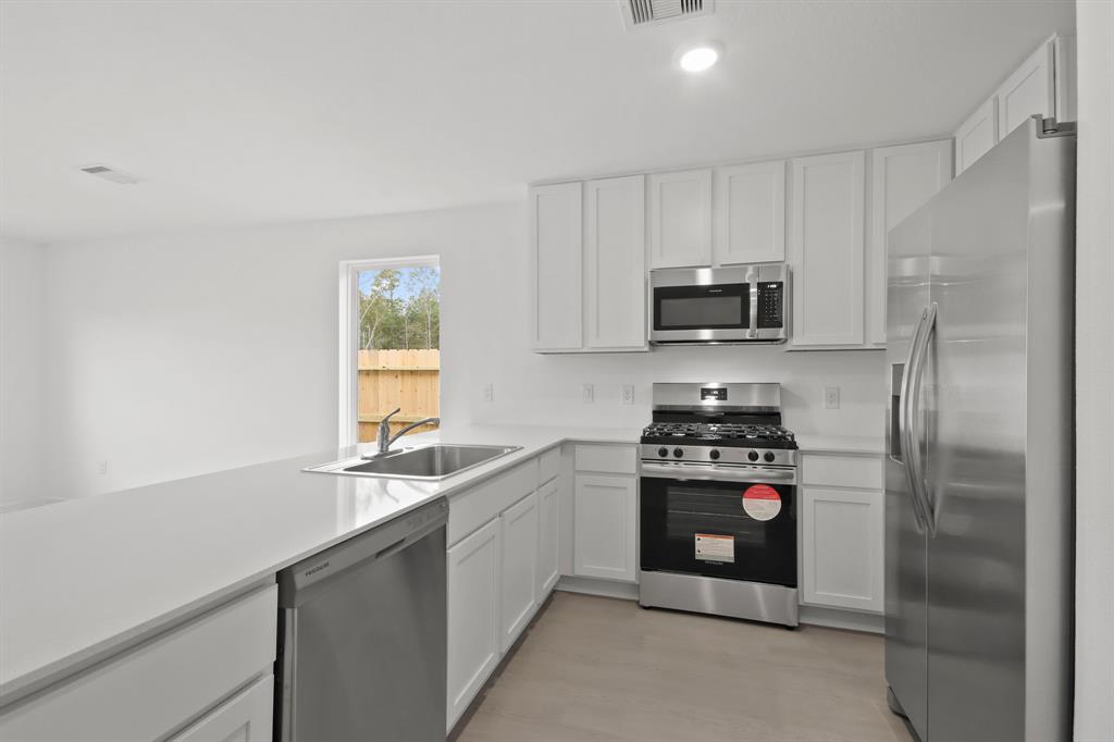 a kitchen with a sink stove and refrigerator