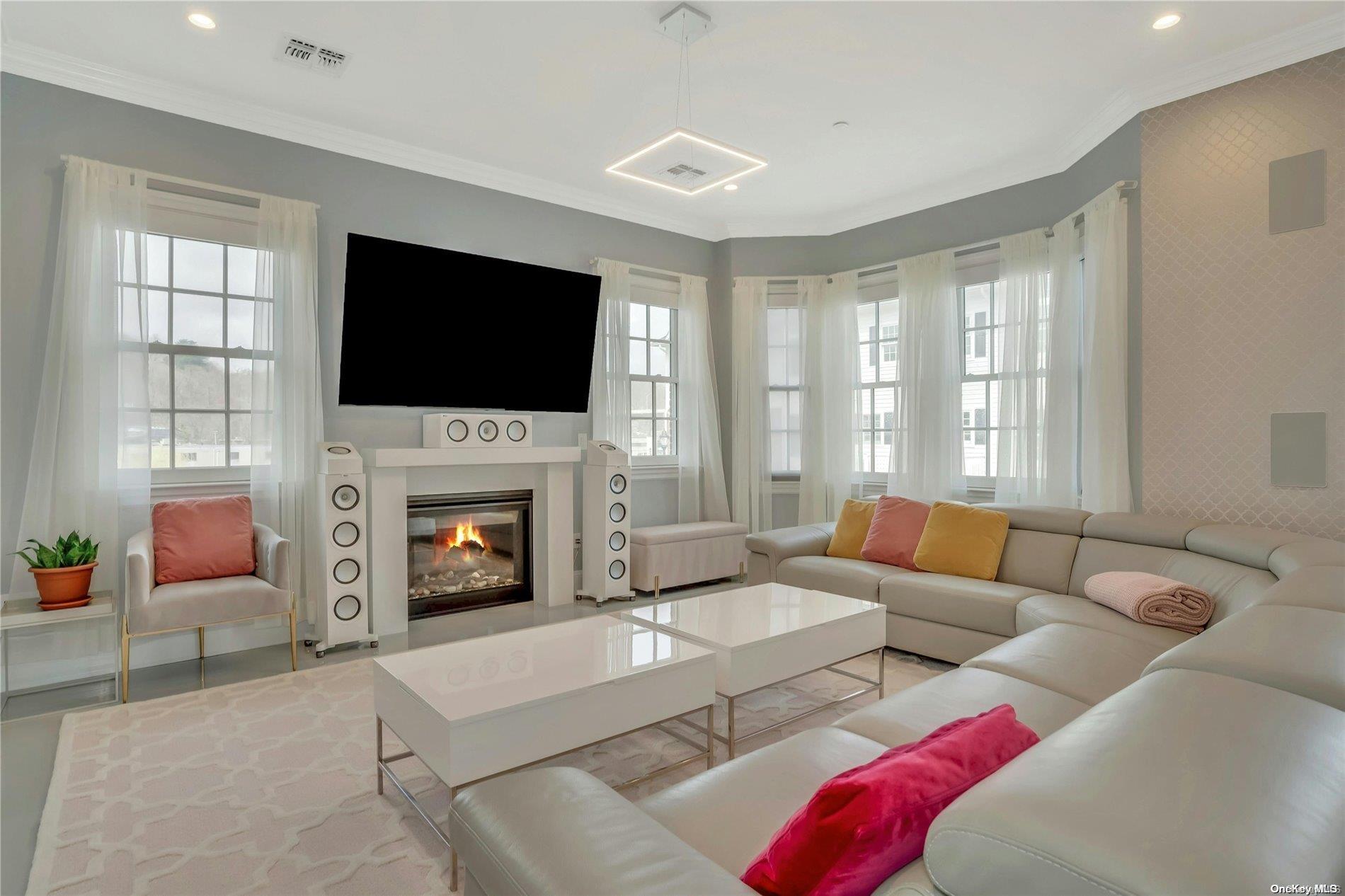 a living room with furniture a fireplace and a flat screen tv