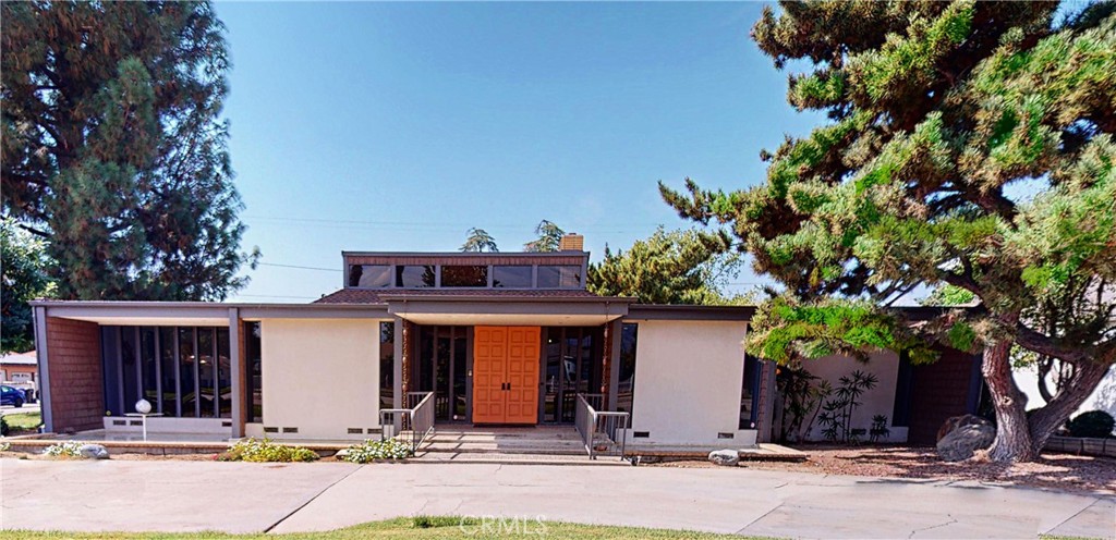 front view of a house with a tree