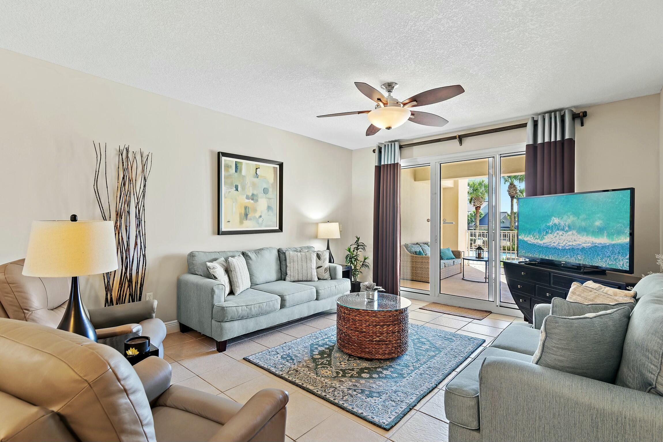 a living room with furniture a rug and a large window