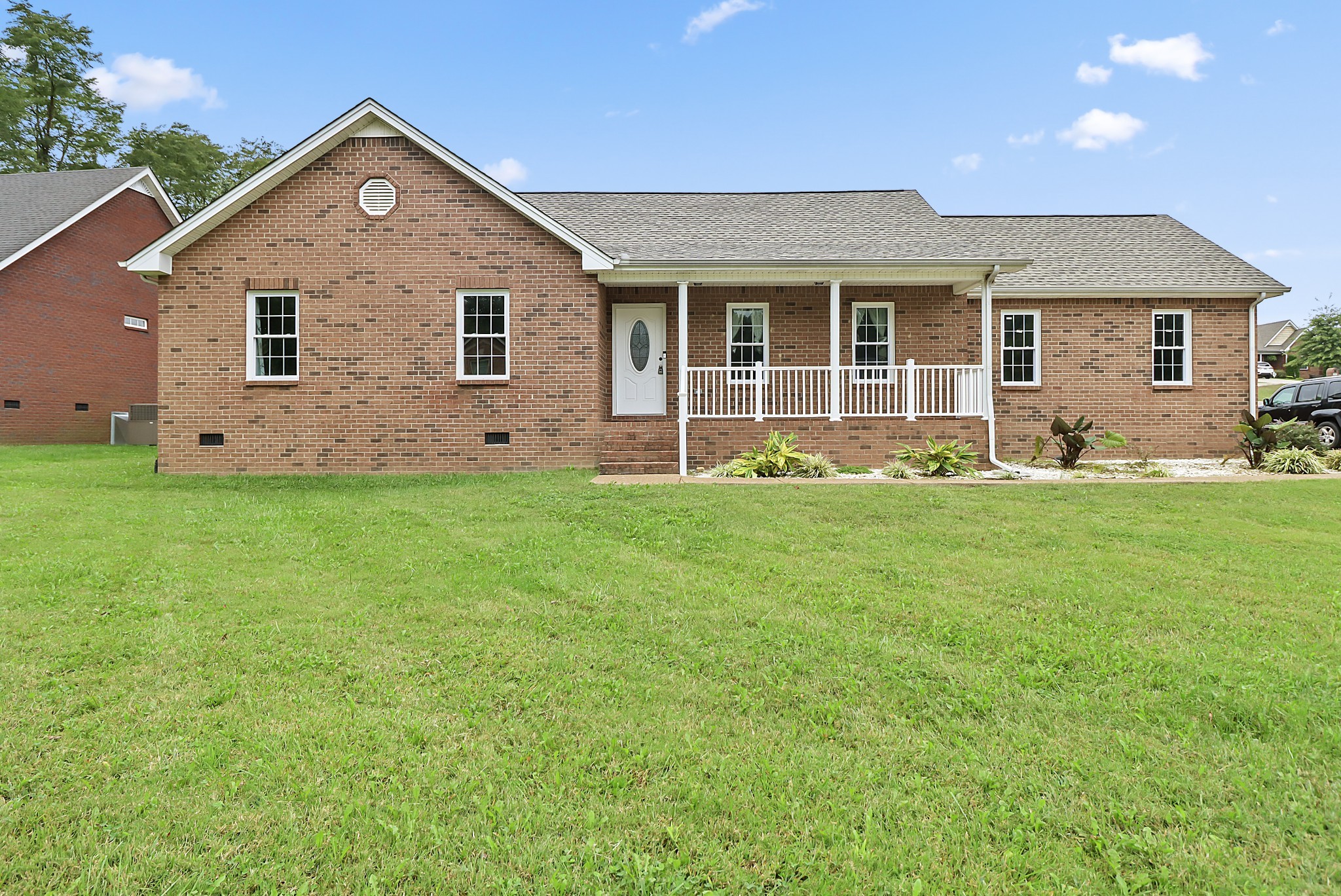 a front view of a house with a yard and yard