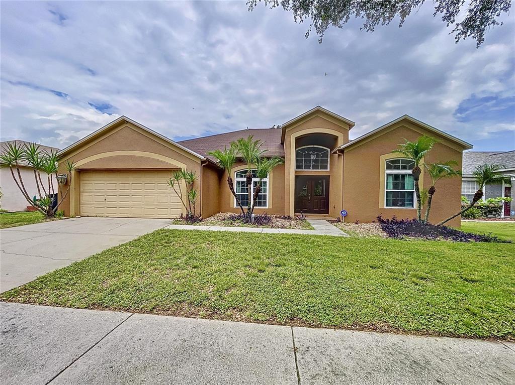 a front view of a house with a yard