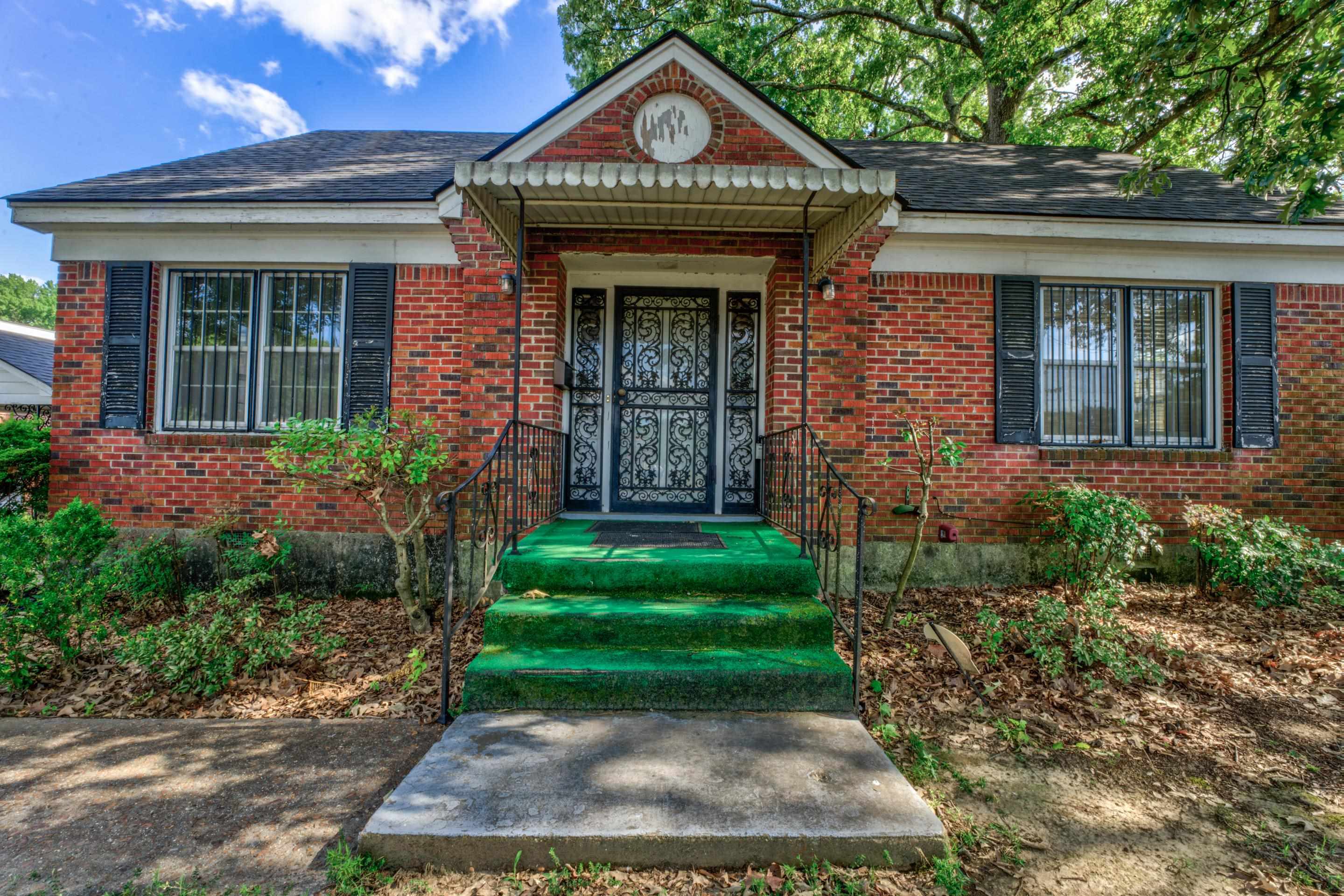 a front view of a house with garden