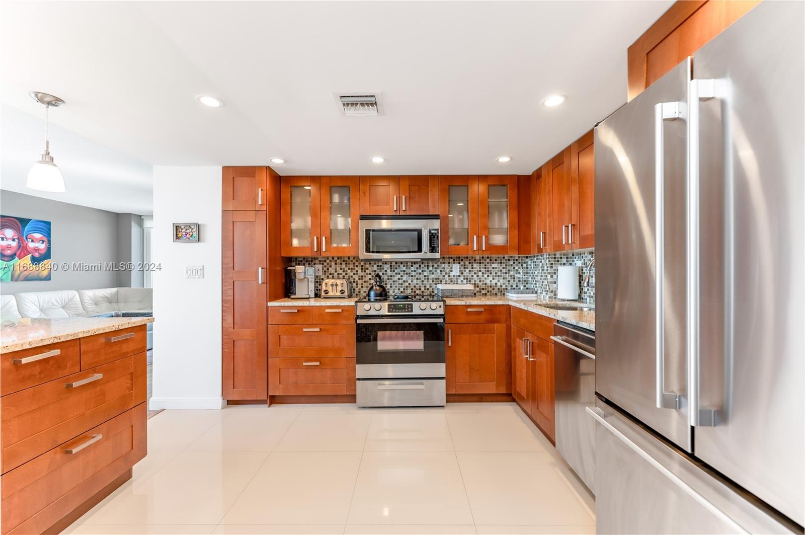 a kitchen with stainless steel appliances granite countertop a refrigerator and stove