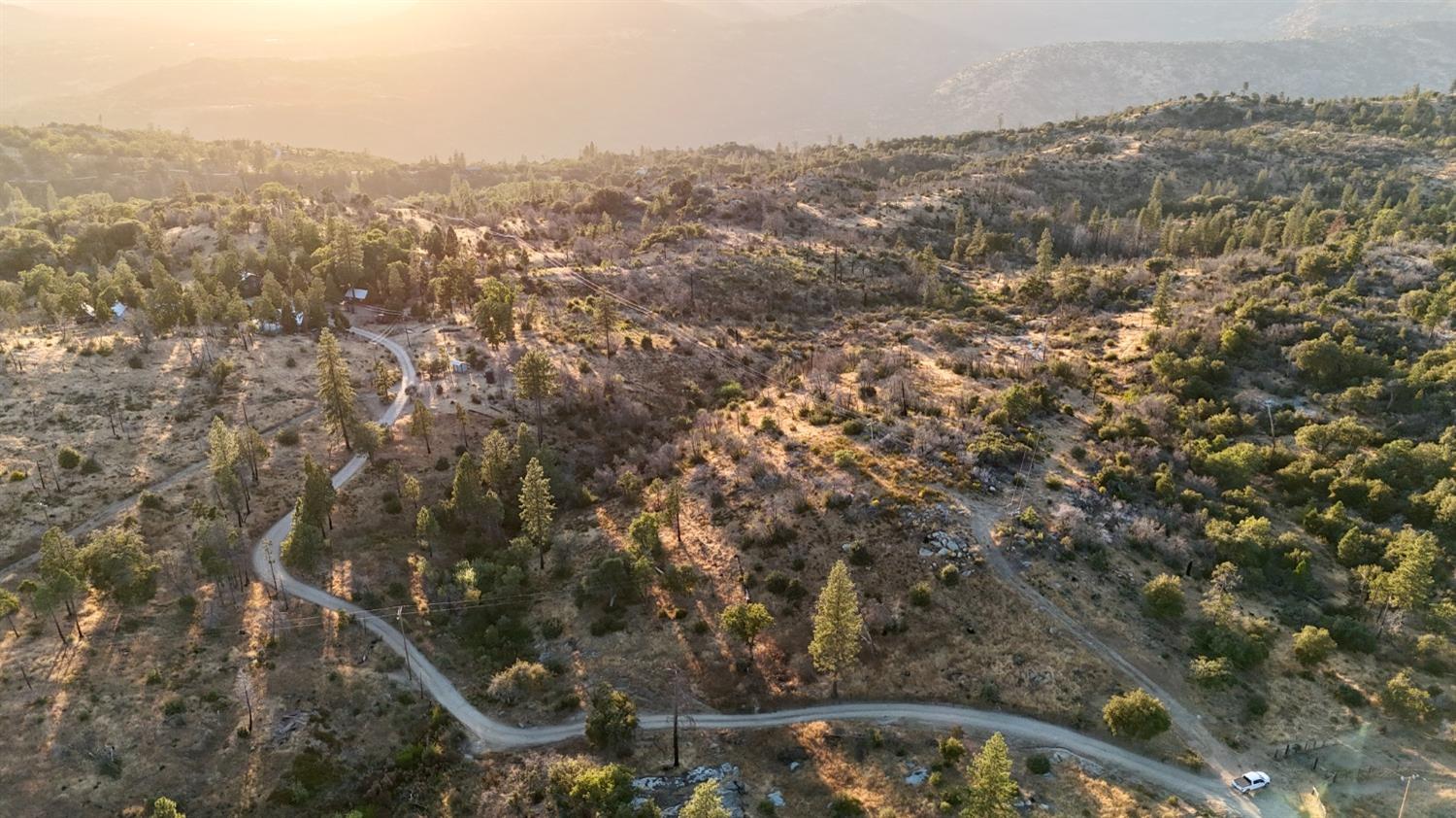 an aerial view of house with yard and mountain view in back