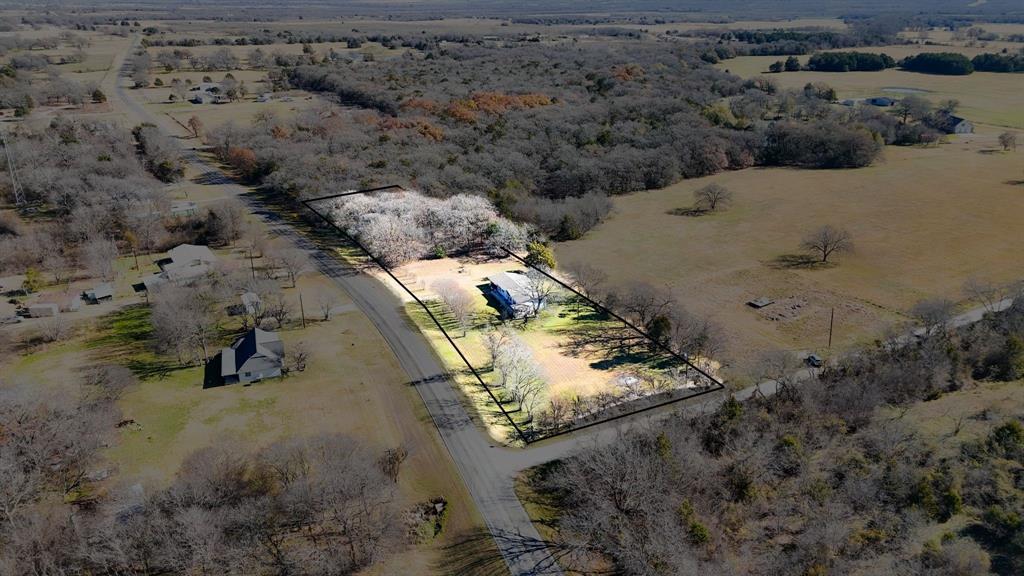 an aerial view of house with a yard