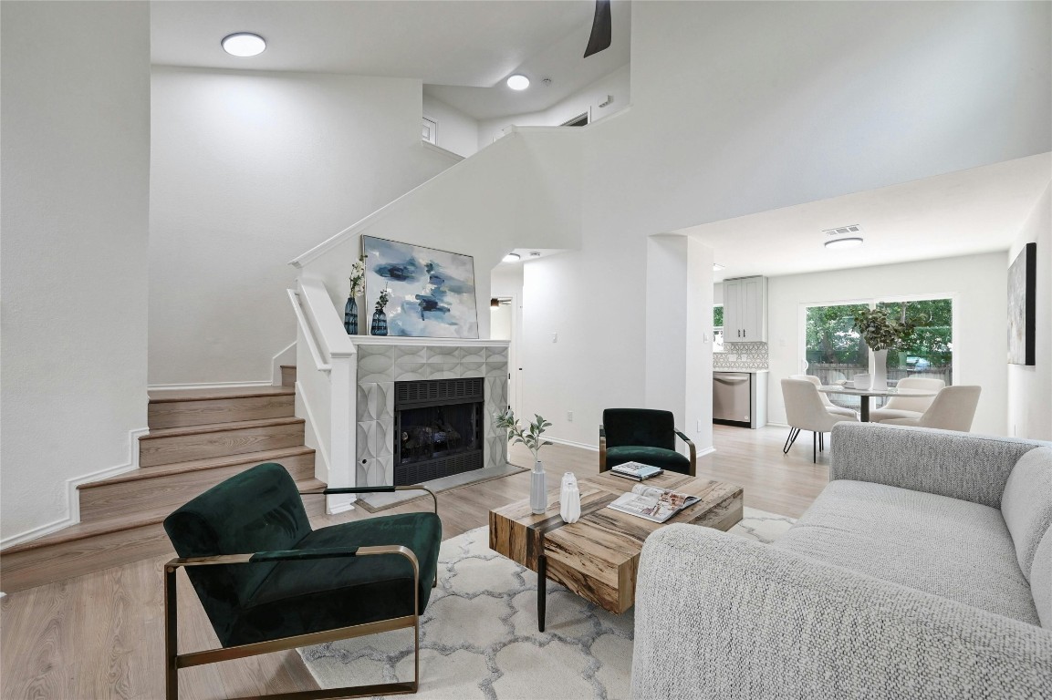 a living room with furniture fireplace and window