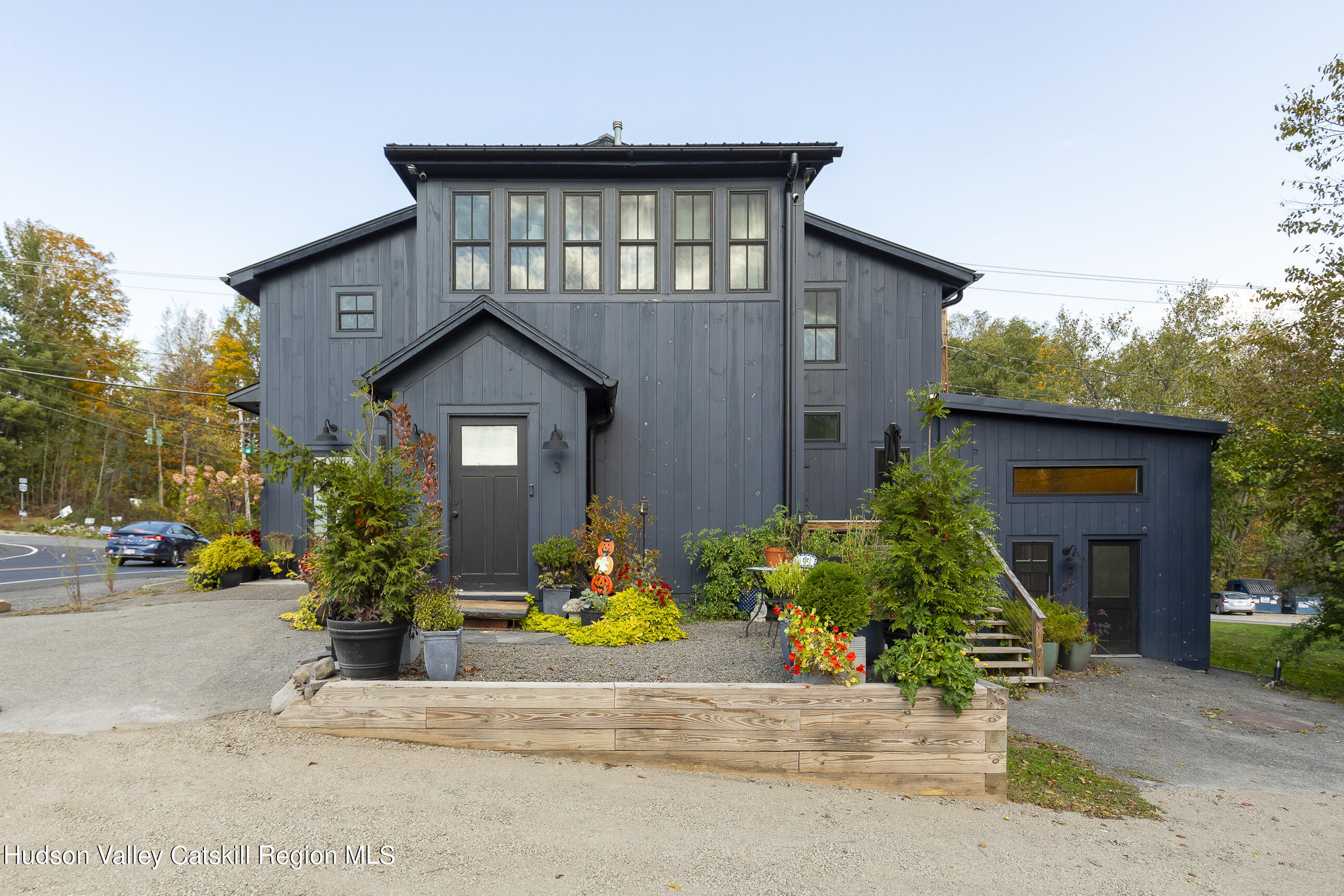 a front view of a house with a yard garage and outdoor seating