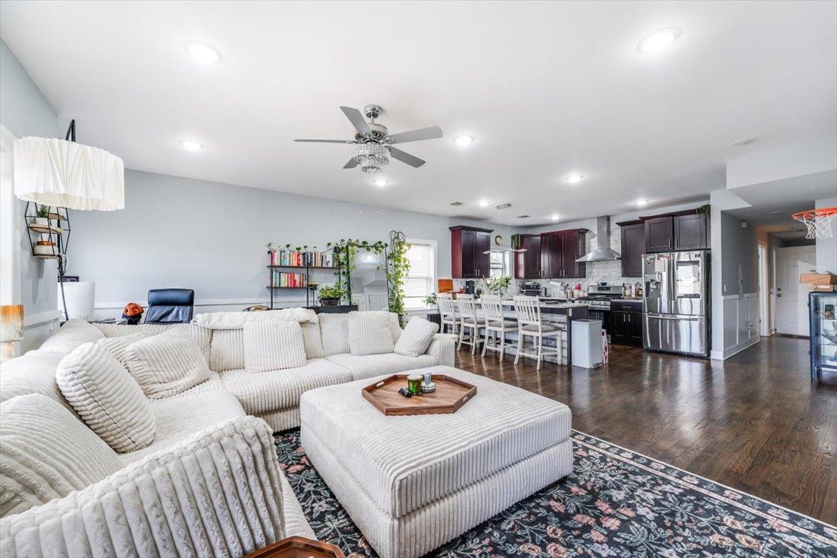 a living room with furniture and kitchen view