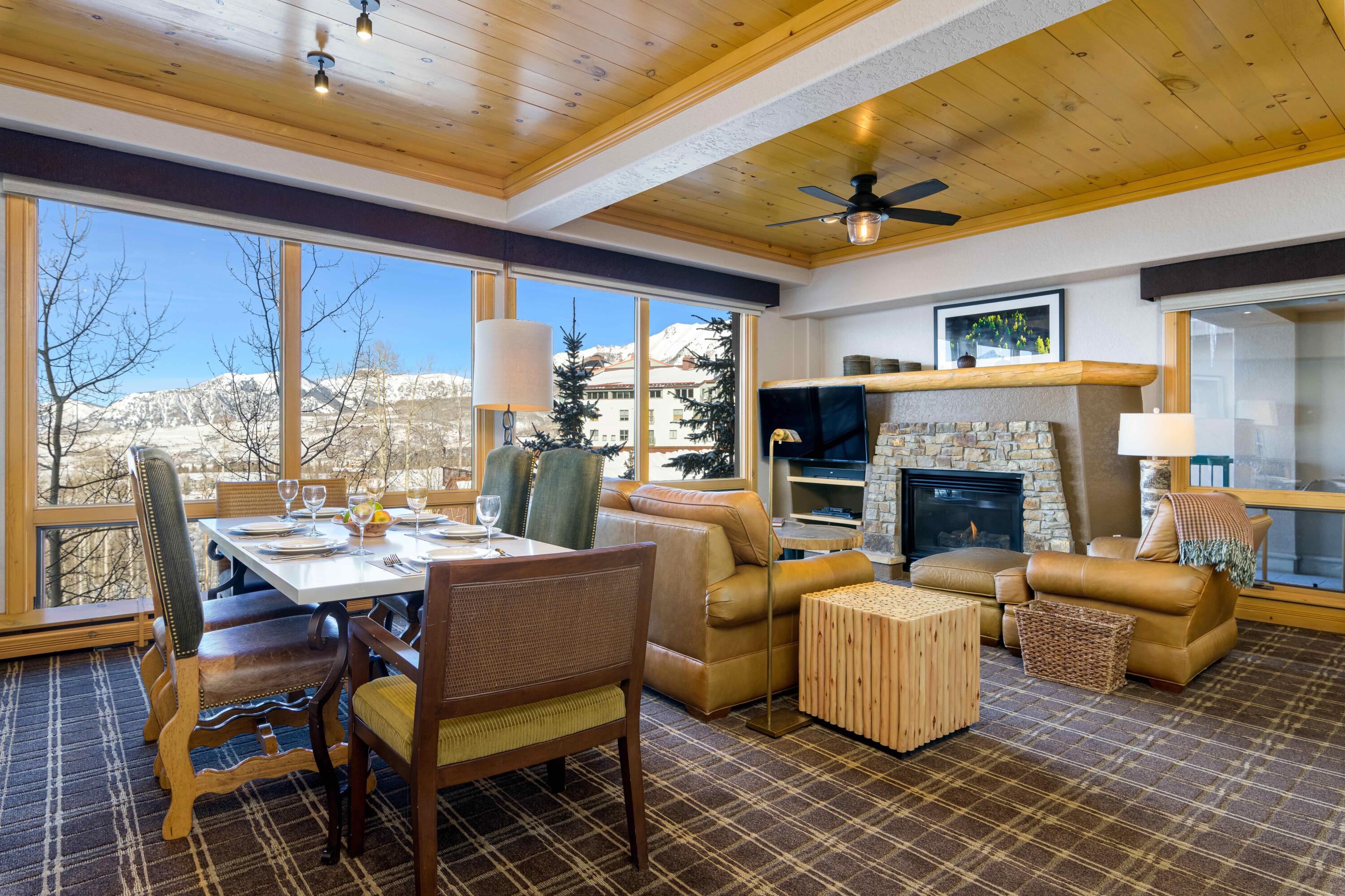 a living room with furniture a fireplace and a large window