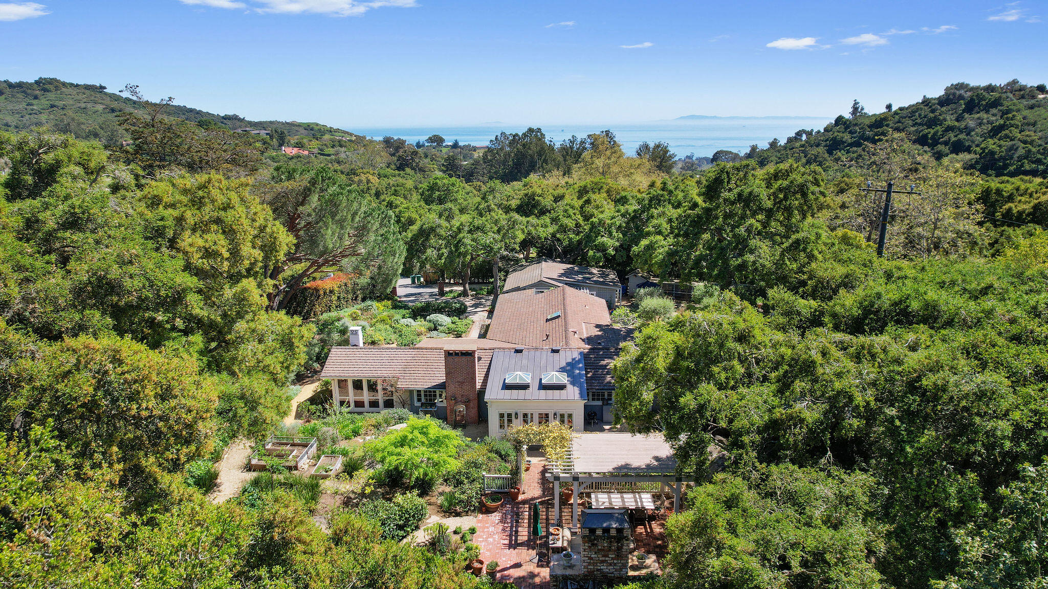 an aerial view of a house with a yard and outdoor seating