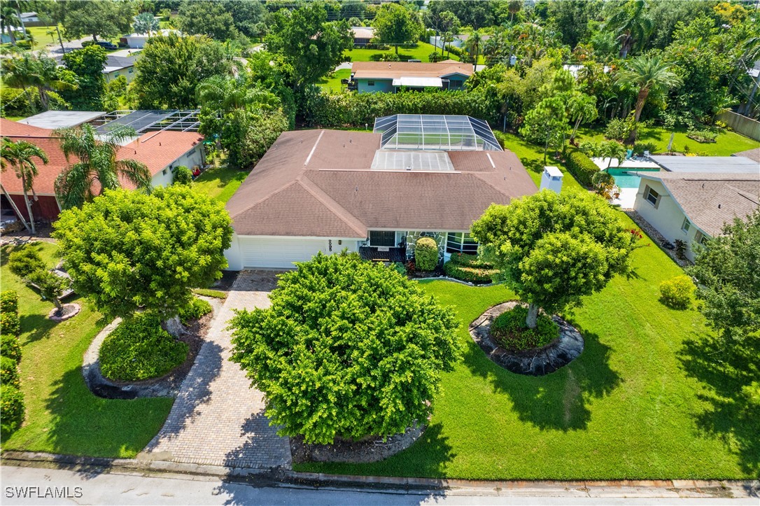 an aerial view of a house with yard outdoor seating and lake view