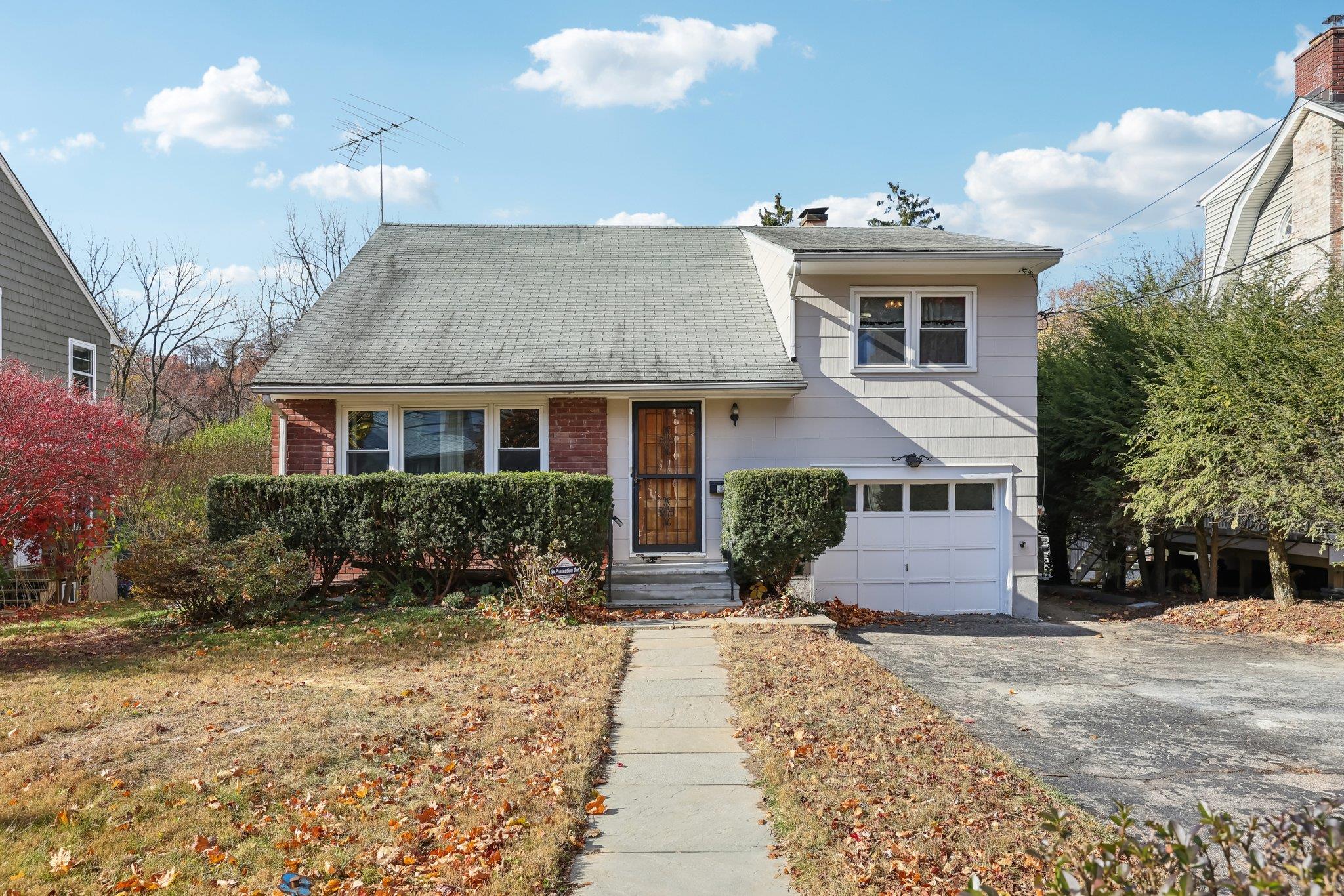 View of front facade featuring a garage