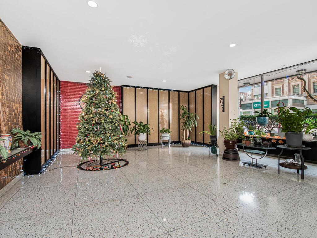 a lobby with furniture and potted plant