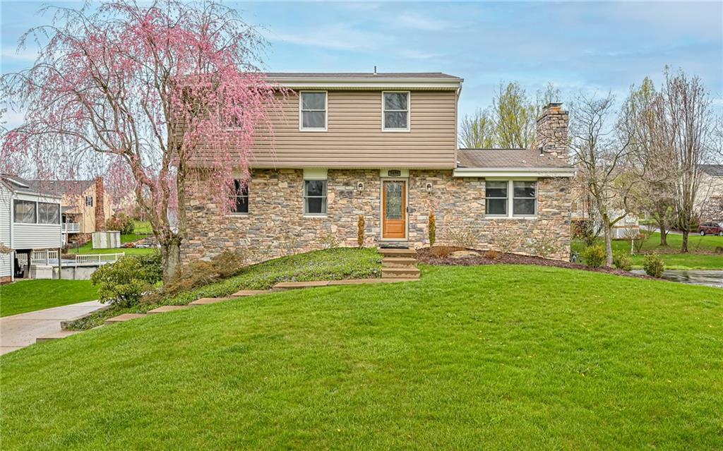 a front view of house with yard and green space