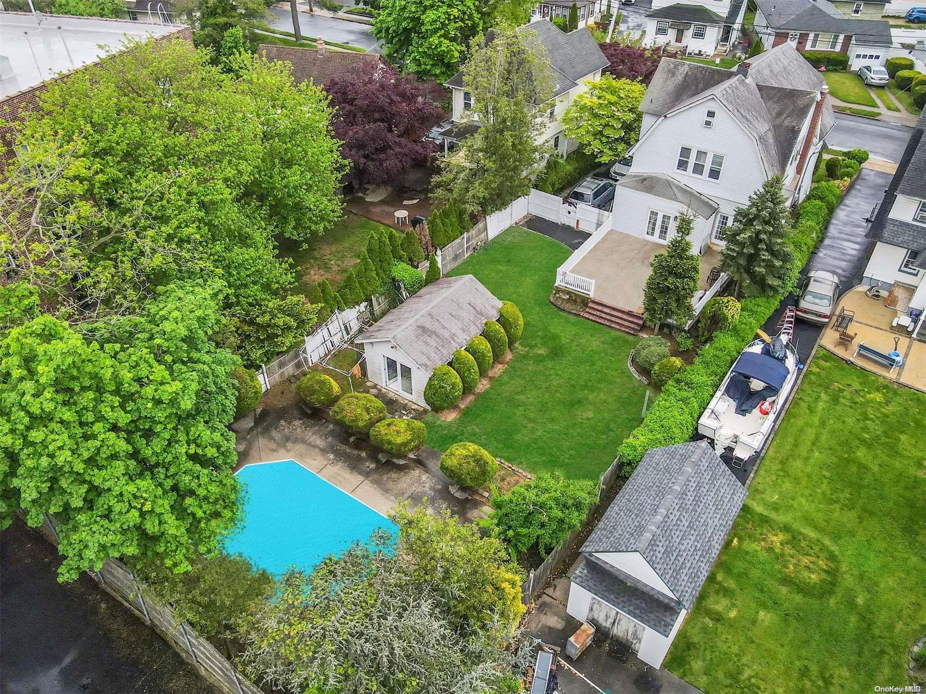 an aerial view of a house with garden space and street view