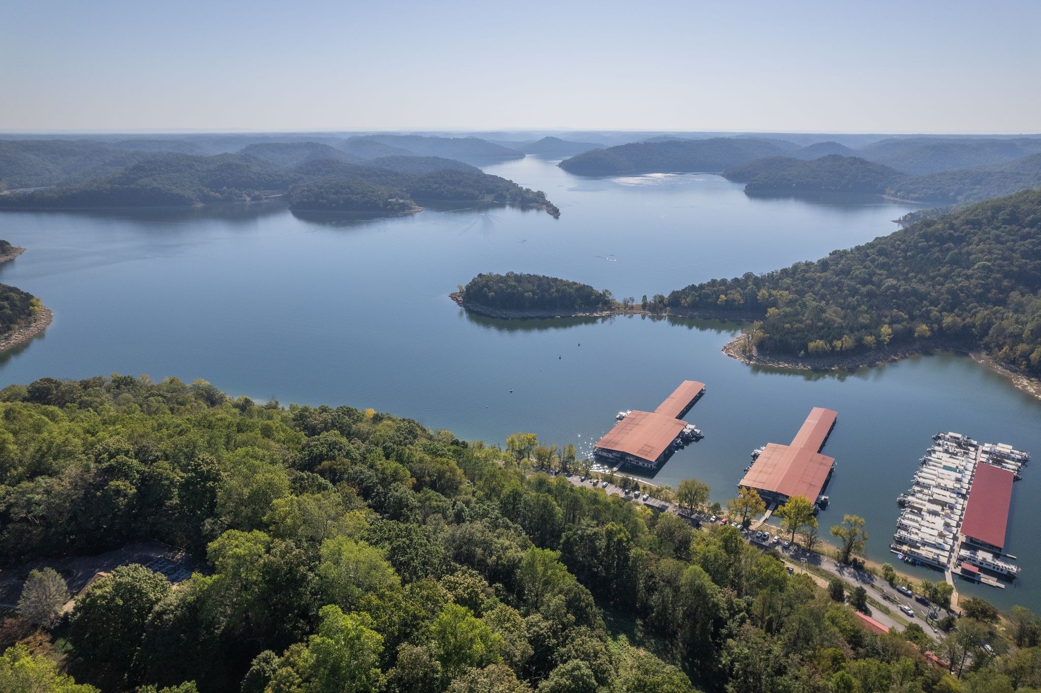 an aerial view of a house with a yard and lake view