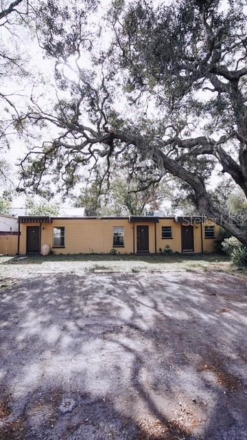 a front view of a house with a yard and trees