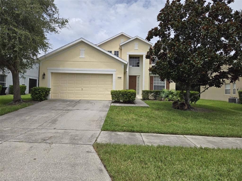 a front view of a house with a yard and garage