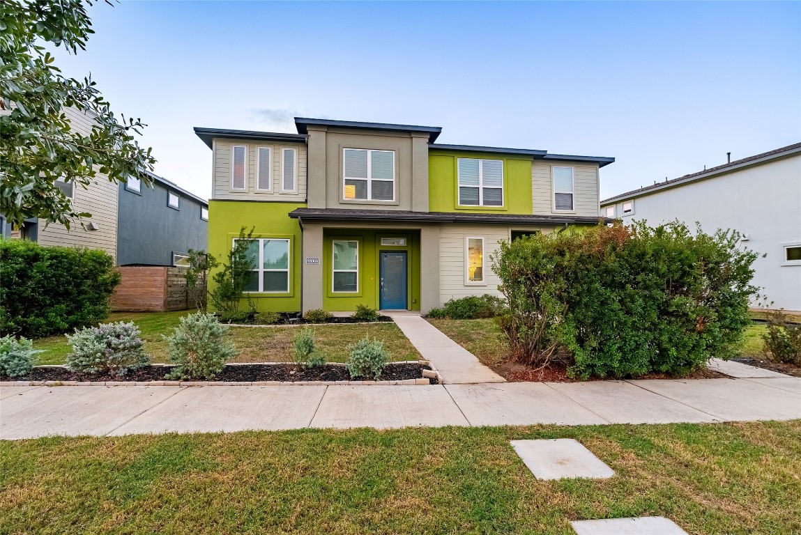 a front view of a house with garden