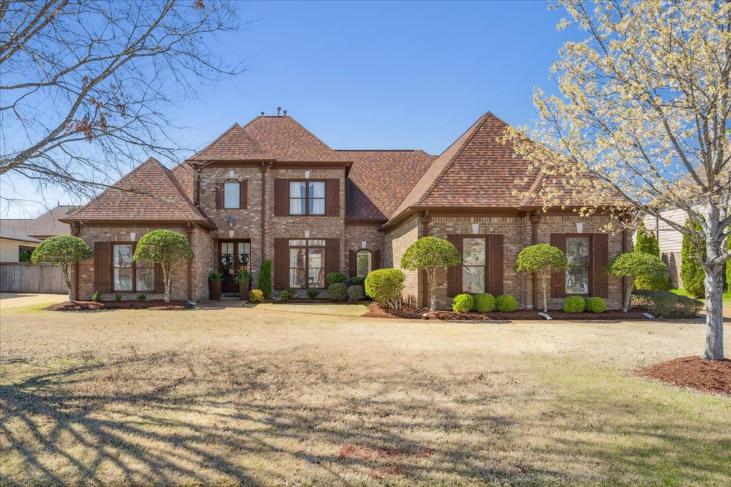 Tudor home with a front lawn