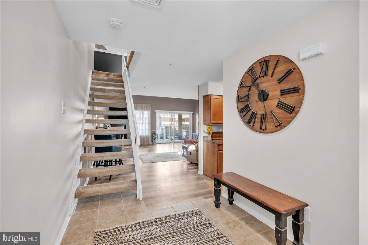 a view of entryway and hall with wooden floor