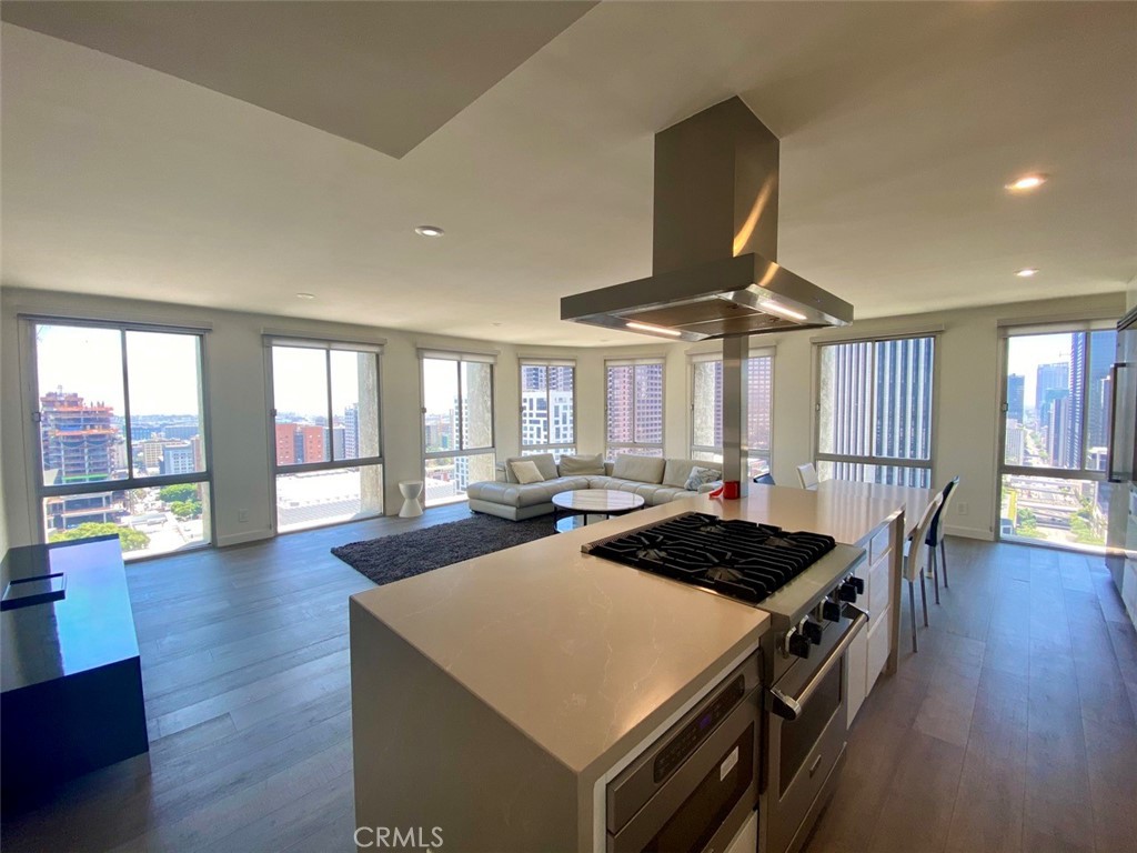 a kitchen that has a stove and a wooden floor