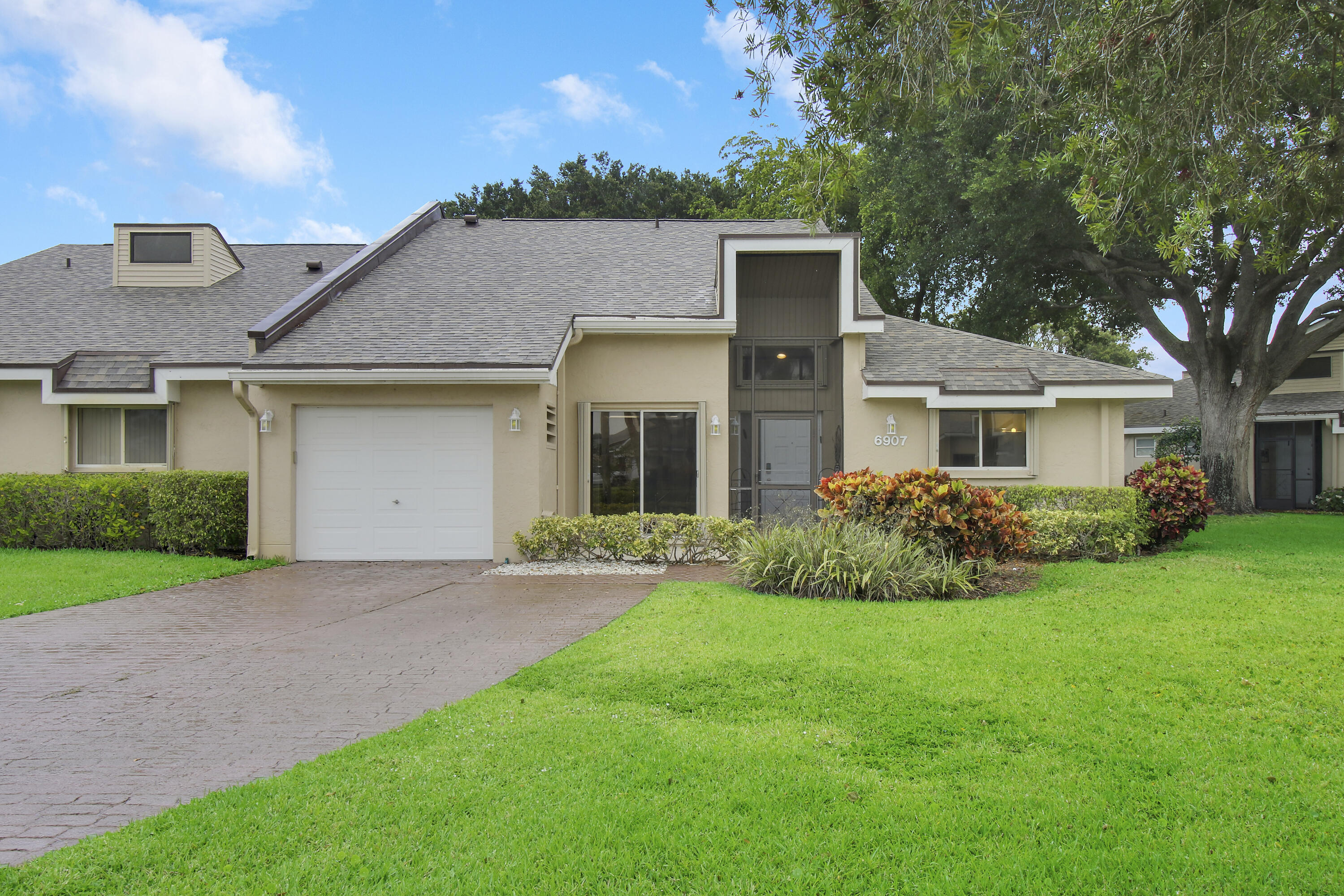 a front view of a house with a garden and yard