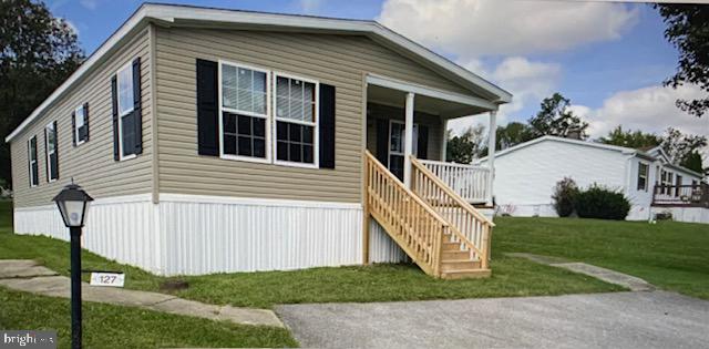 a view of a house with yard and stairs