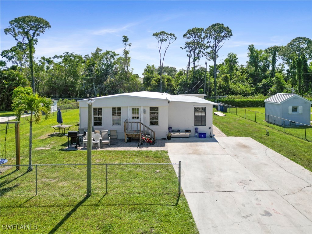 a view of a house with backyard and a patio