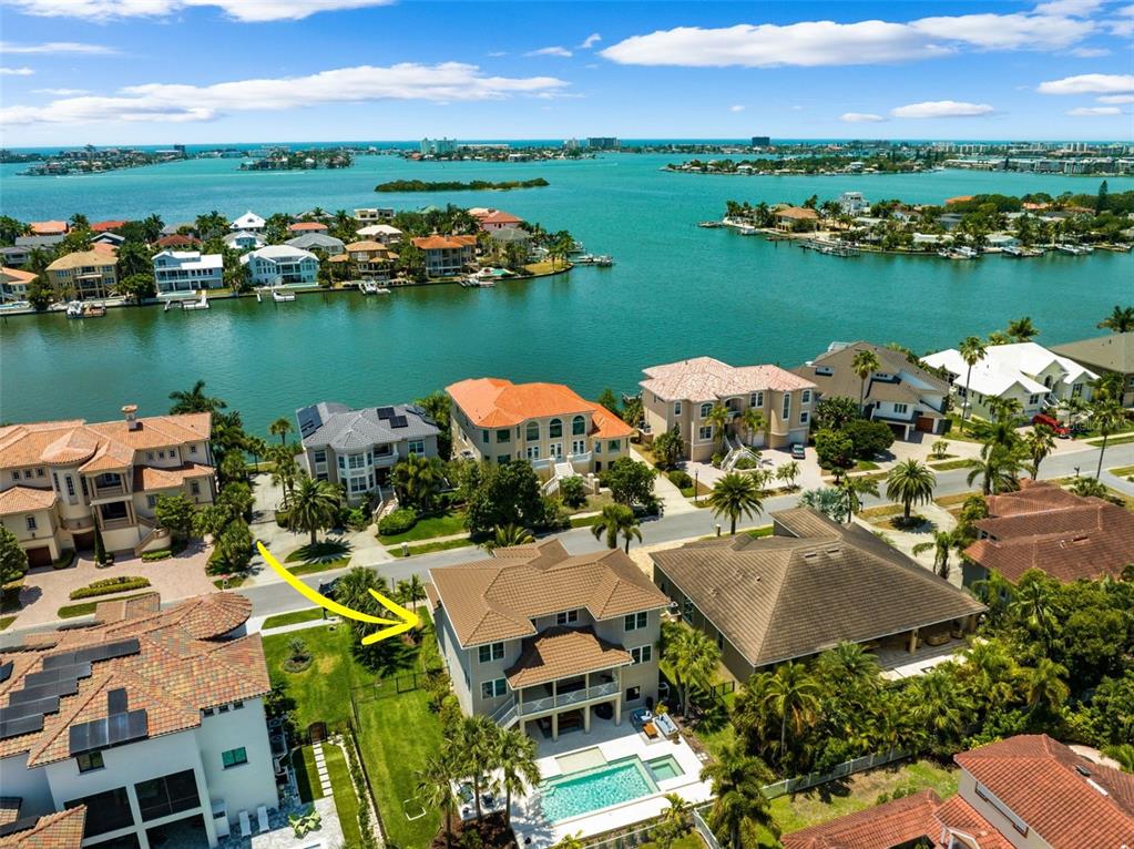 an aerial view of a house with garden space and lake view