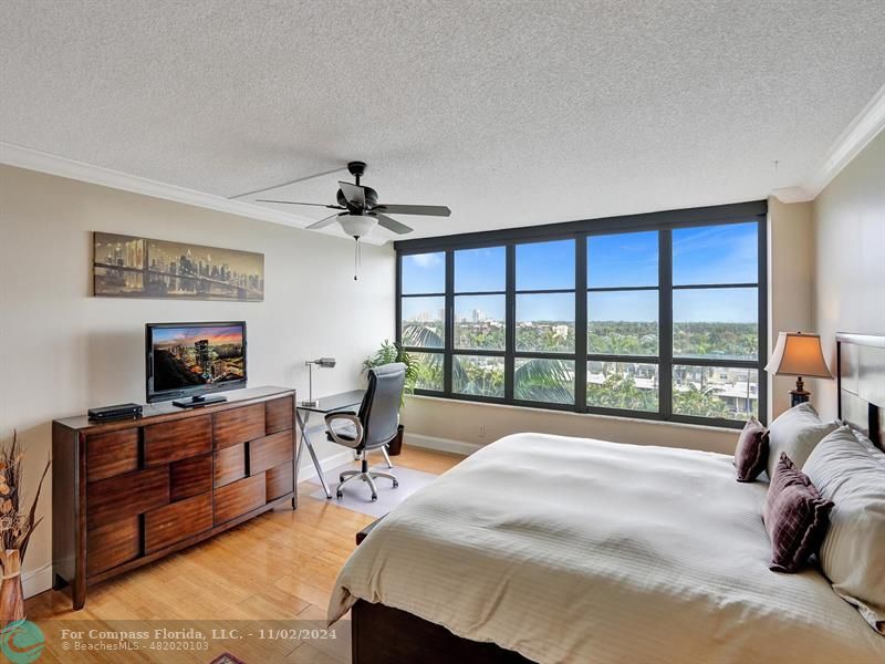 a spacious bedroom with a bed and a large window